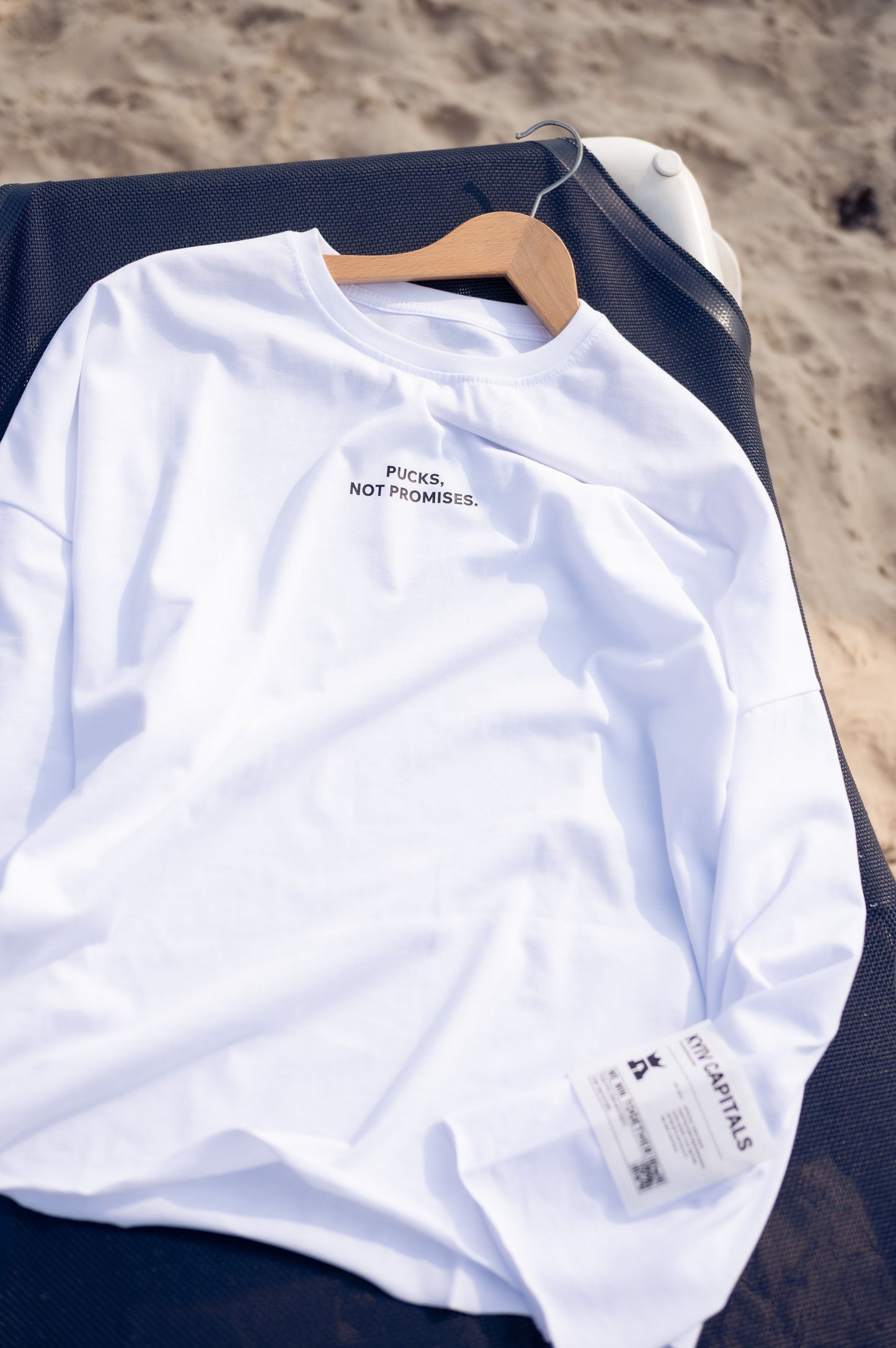 Білий лонгслів “Pucks, Not Promises”